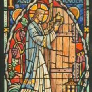 Stained glass window of a church picturing Letter to Laodicea